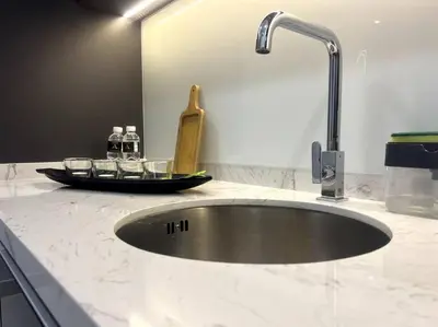 a kitchen counter with a sink and a faucet at Novo KL, Astonishing Unique Executive Suite in Kuala Lumpur