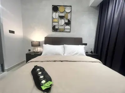 a bedroom with a large white bed with a black headboard at Novo KL, Astonishing Unique Executive Suite in Kuala Lumpur