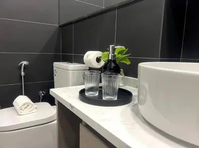a bathroom with a white sink and a toilet at Novo KL, Astonishing Unique Executive Suite in Kuala Lumpur