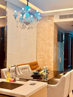 a kitchen with a chandelier and a dining room at Dorsett Infinity Pool KL in Kuala Lumpur