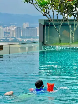 a person in a swimming pool in a city at Dorsett Infinity Pool KL in Kuala Lumpur