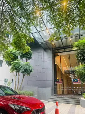 a red car parked in front of a building at Dorsett Infinity Pool KL in Kuala Lumpur