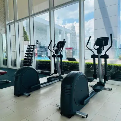 a gym with cardio machines in a large window at The Platinum KLCC By Classy in Kuala Lumpur