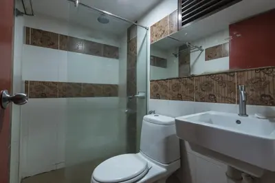 a bathroom with a toilet and a sink and a shower at Grand Orchard Hotel Premier in Kuala Lumpur