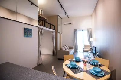 a living room with a table and a dining room at KLCC EST Bangsar By PSM in Kuala Lumpur