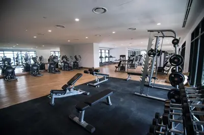 a gym with several treadmills and exercise machines at KLCC EST Bangsar By PSM in Kuala Lumpur