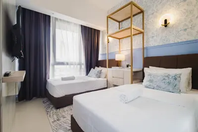 a hotel room with two beds and a window at Novo Kuala Lumpur in Kuala Lumpur