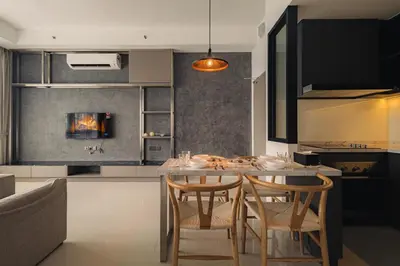 a kitchen with a table and chairs in a room at Novo Kuala Lumpur in Kuala Lumpur