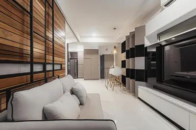 a living room with a white couch and a television at Novo Kuala Lumpur in Kuala Lumpur