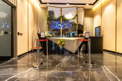 a lobby with a table and a painting on the wall at Novo Kuala Lumpur in Kuala Lumpur