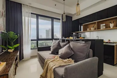a living room with a couch and a kitchen at Novo Kuala Lumpur in Kuala Lumpur