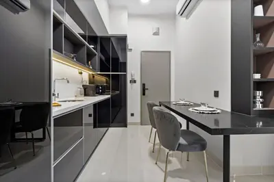 a kitchen with a black table and chairs at Novo Kuala Lumpur in Kuala Lumpur