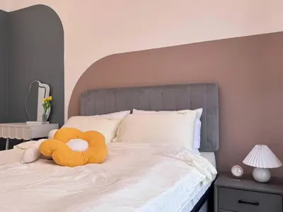 a teddy bear laying on top of a bed at NEW Scandinavian Modern TRX KL 2 Bedrooms in Kuala Lumpur