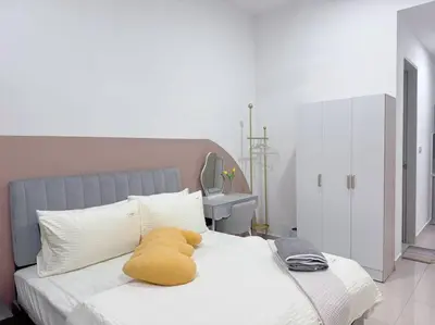 a yellow pillow on a white bed in a bedroom at NEW Scandinavian Modern TRX KL 2 Bedrooms in Kuala Lumpur