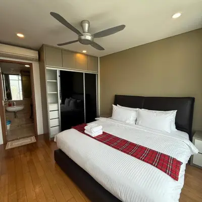 a bedroom with a large bed with a ceiling fan at vortex klcc apartment by Dream NIGHT in Kuala Lumpur