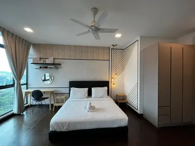 a bedroom with a bed with a ceiling fan and a desk at Velocity Residence Suites By PSM in Kuala Lumpur