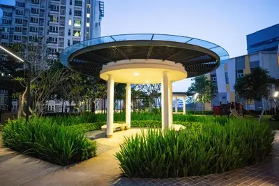 a circularvisor in a park with grass and buildings at Velocity Residence Suites By PSM in Kuala Lumpur
