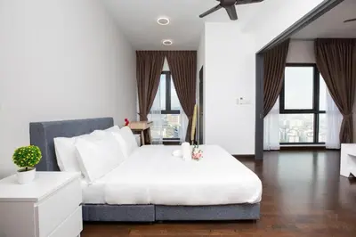 a bedroom with a large white bed and windows at Velocity Residence Suites By PSM in Kuala Lumpur
