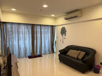 a living room with a black couch in front of a window at 12mins walk to KLCC in Kuala Lumpur