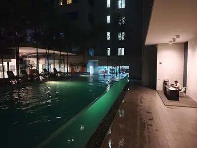 a swimming pool in a building at night at 12mins walk to KLCC in Kuala Lumpur