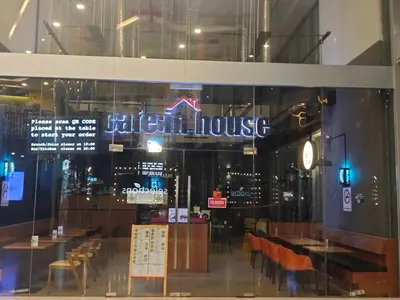 a restaurant with a sign that reads illinois house at 12mins walk to KLCC in Kuala Lumpur
