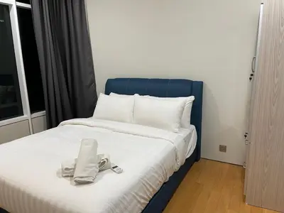 a bed with a pair of shoes sitting on it at Sky Suites KL City Center in Kuala Lumpur