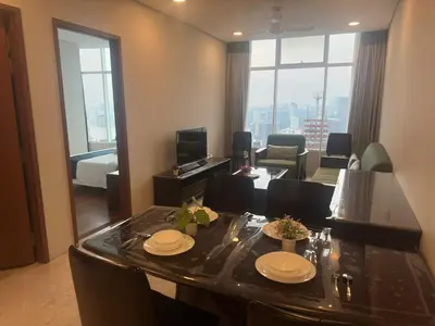 a living room with a dining table and a living room at Sky Suites KL City Center in Kuala Lumpur