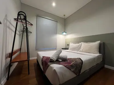 a bedroom with a large bed with a tripod at Sky Suites KL City Center in Kuala Lumpur