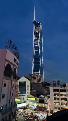 a tall skyscraper in the middle of a city at Cojoy Hotel @ Chinatown in Kuala Lumpur