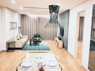 a living room with a table and a couch at THE APARTMENT at 188 SUITES KLCC in Kuala Lumpur