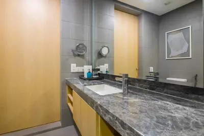 a bathroom with a sink and a large mirror at THE APARTMENT at 188 SUITES KLCC in Kuala Lumpur