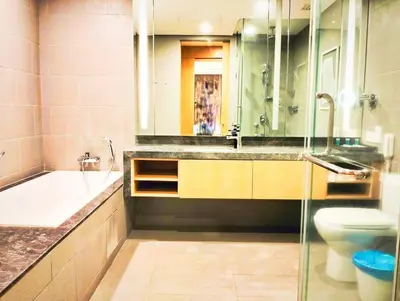 a bathroom with a sink and a tub and a toilet at THE APARTMENT at 188 SUITES KLCC in Kuala Lumpur