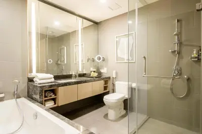 a bathroom with a toilet and a sink and a shower at THE APARTMENT at 188 SUITES KLCC in Kuala Lumpur