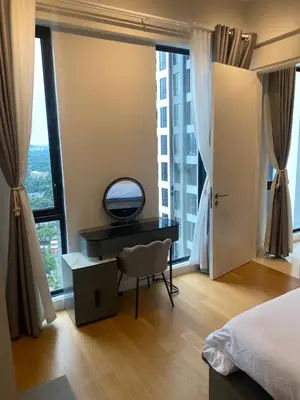 a bedroom with a desk and a large window at SS KL Sentral by NomadNest in Kuala Lumpur