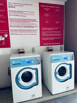 two washing machines and a dryer in a room at Premium Stay at Bukit Bintang City Centre by Premium Stay in Kuala Lumpur