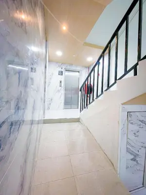 a bathroom with a walk in shower and a tile floor at StarQ Hotel Kuala Lumpur in Kuala Lumpur