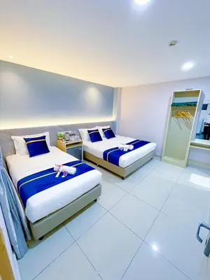 a bedroom with two beds with dolls on them at StarQ Hotel Kuala Lumpur in Kuala Lumpur