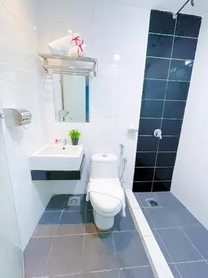 a bathroom with a white toilet and a sink at StarQ Hotel Kuala Lumpur in Kuala Lumpur