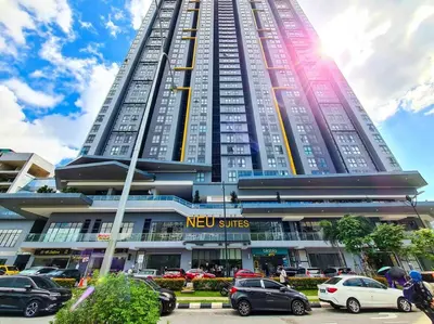a tall building with cars parked in front of it at Neu Suites Studio Room - 3km to KLCC, 8 mins walk to LRT in Kuala Lumpur