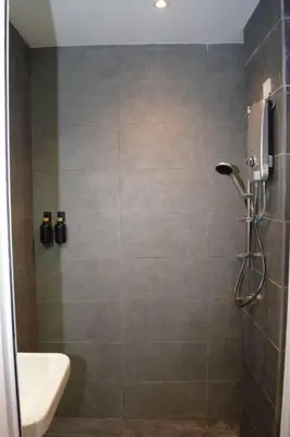 a bathroom with a shower with a toilet and a sink at Neu Suites Studio Room - 3km to KLCC, 8 mins walk to LRT in Kuala Lumpur