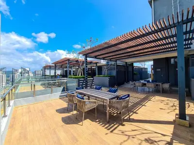 a wooden deck with a table and chairs on a building at Neu Suites Studio Room - 3km to KLCC, 8 mins walk to LRT in Kuala Lumpur