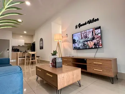 a living room with a tv on a wall at Razak City Residences, Sungai Besi by Rverse Suite in Kuala Lumpur