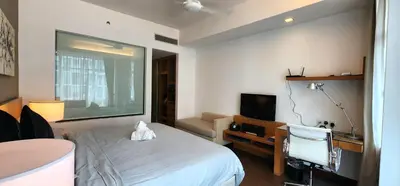 a hotel room with a bed and a desk and a television at 163 SUPER KING BED STUDIO near Petronas Twin Tower KLCC KL Convention Center by Zen Glo in Kuala Lumpur