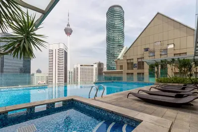 a swimming pool with a view of the city at 163 SUPER KING BED STUDIO near Petronas Twin Tower KLCC KL Convention Center by Zen Glo in Kuala Lumpur