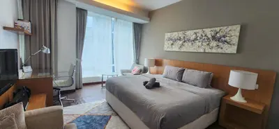 a bedroom with a bed and a desk and a television at 163 SUPER KING BED STUDIO near Petronas Twin Tower KLCC KL Convention Center by Zen Glo in Kuala Lumpur