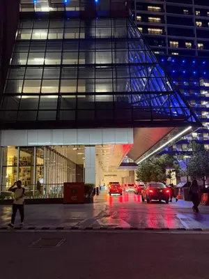 a building with cars parked in front of it at night at The Platinum KLCC by Skyline in Kuala Lumpur
