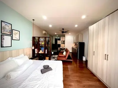 a bedroom with a white bed with a hat on it at Premium Cozy Studio Near Mid Valley in Kuala Lumpur