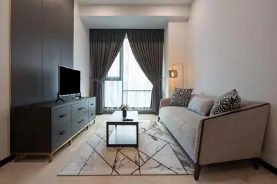 a living room with a couch and a tv at Opus Signatures ChinaTown 118 in Kuala Lumpur