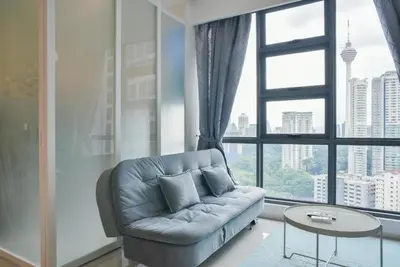 a living room with a couch and a large window at Home Sweet Home at Robertson Bukit Bintang,trx,klcc,pavilion,lalaport in Kuala Lumpur
