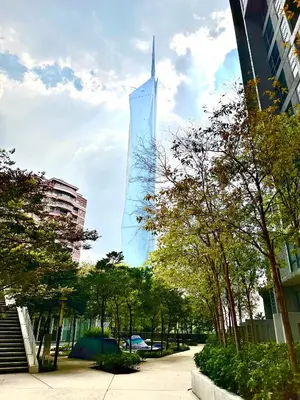 a tall glass building in a city with trees at Home Sweet Home at Robertson Bukit Bintang,trx,klcc,pavilion,lalaport in Kuala Lumpur